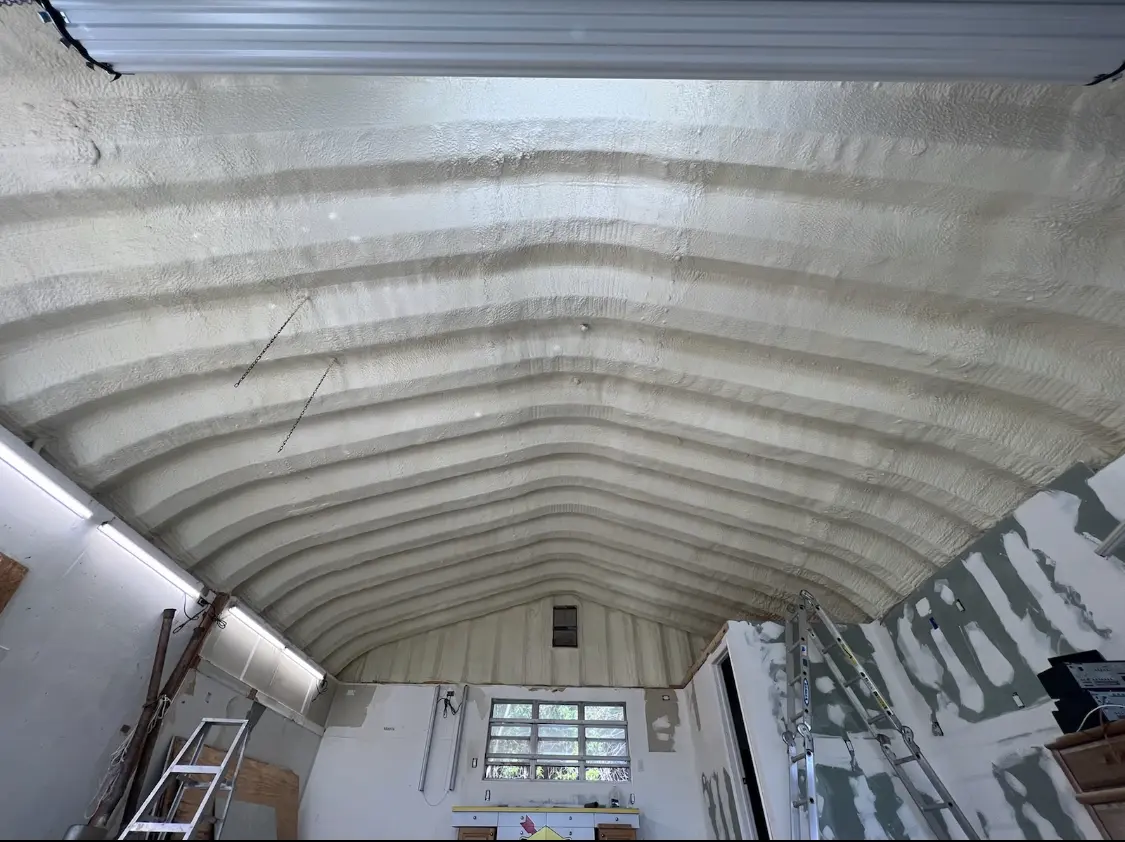 Spray polyurethane foam applied to the underside of a metal roof deck in Stratford